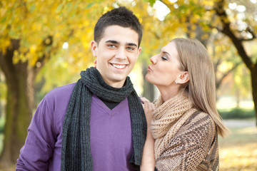 young couple in love kissing in autumn park