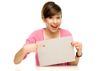Fototapeta premium Young woman pointing at blank poster