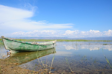 Fototapeta premium boat on lake under beautiful blue sky