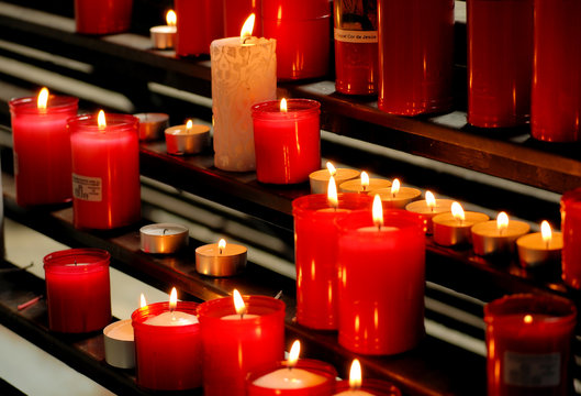 red burning candles in a temple church