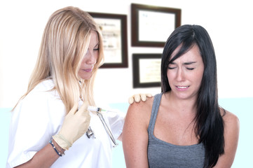 Doctor doing vaccine injection to a woman