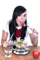 young woman eating vegetable salad