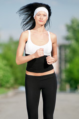 Woman running in green park