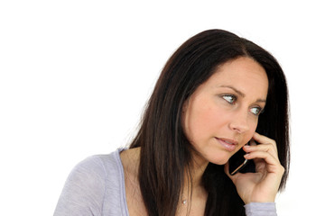 Concerned woman on mobile telephone