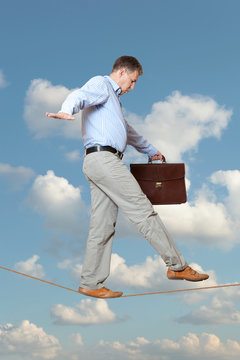 Businessman rope-walker