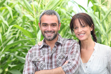 Couple in front of green plants