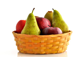 apples, kiwi, pears and an italian peach in wicker basket