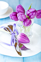 Easter place setting with purple tulips