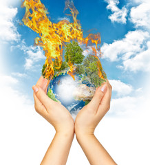 Womanish hands holding burning Earth
