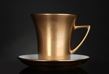 golden cup of coffee on gray background