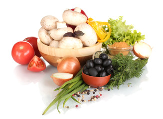 mushrooms in a wooden bowl and vegetables isolated on white