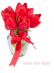 Red tulips in glass jar