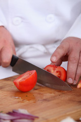 Chef chopping tomato