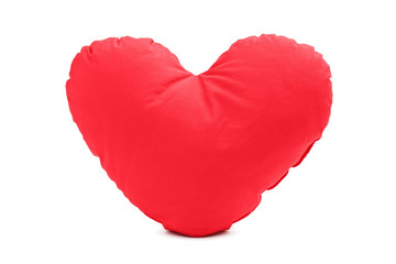 A studio shot of a red heart shaped pillow
