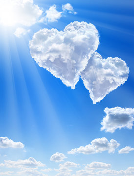 Hearts in clouds against a blue clean sky