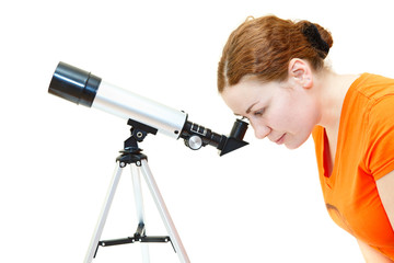 Young woman in orange t-shirt looking through telescope on white