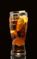 Iced tea with lemon and lime on black background