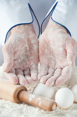 Close-up of baker's hands covered with flour, studio shot