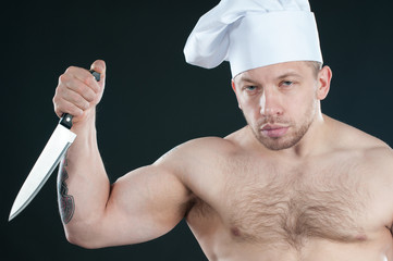 Studio shot of bare torso chef with a kitchen knife