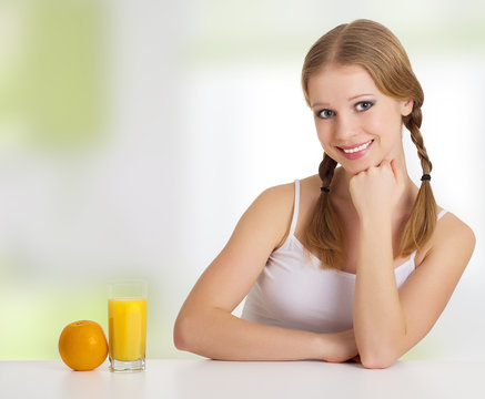 beautiful happy cheerful young woman with orange juice