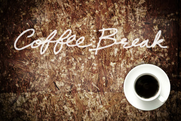 Coffee cup on grunge wood table