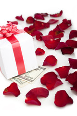 Gift box, rose petals on white background.