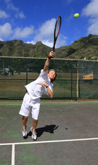 Tennis player serves the ball with strength