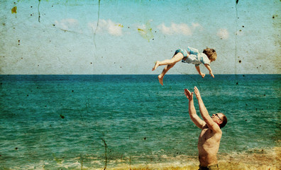 father and son on the beach. Photo in old image style. - obrazy, fototapety, plakaty