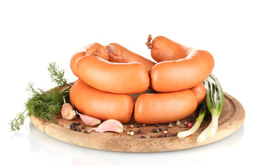 tasty sausages on wooden board and spices isolation on white