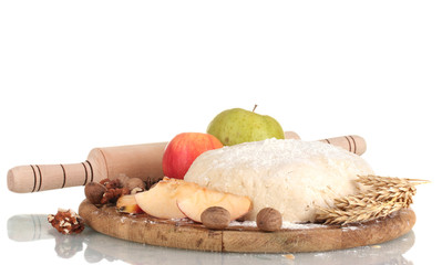 ingredients for homemade pie on wooden plate isolated on white
