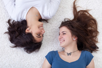 Happy girls laying on the floor