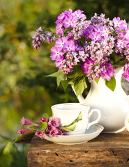 porcelain cup with coffee and lilac