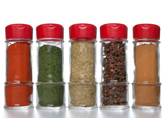 Various spices in small glass bottles
