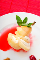 Pear with wine sauce in plate
