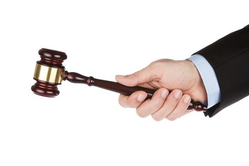 Male hand holding wooden gavel isolated on white background