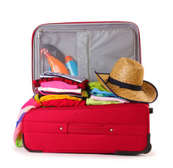 Open red suitcase with clothing isolated on a white