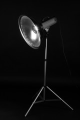 Studio flash with beauty dish on grey background