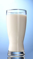 glass of milk on blue background