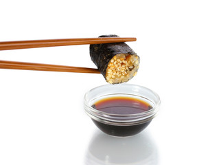 Dipping roll in sauce isolated on white