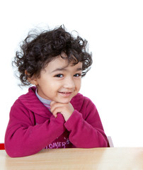 Smiling portrait of a Cute Toddler Girl Sitting at a Desk, Isola