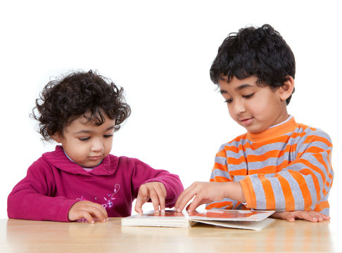 Siblings Reading a Picture Book Together, Isolated, White