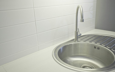 Faucet in the kitchen is stainless