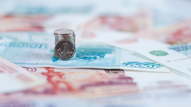 Russian Kopeck on background of large banknotes