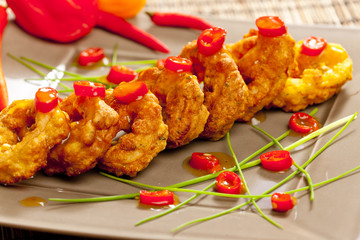 fried sepia rings in dough with chilli