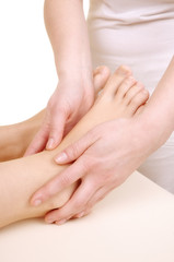 massage the feet of a young woman