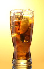 Iced tea with lemon and lime on yelow background