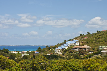 Fototapeta na wymiar Sailboat in Bay Beyond Barbados Homes