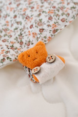 Teddy bear plush fabric background with staple and flowers
