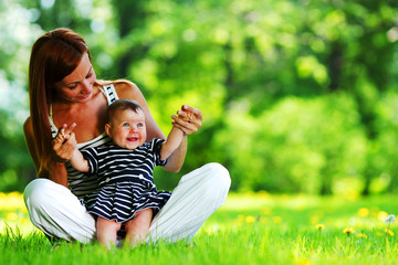 Mother and daughter on the green grass