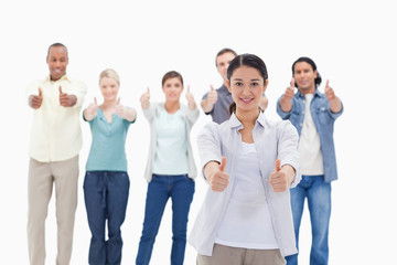 Close-up of people smiling with their thumbs-up